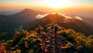 Hikers ascending Mount Rinjani at sunrise with lush green mountains and volcanic terrain in the background.